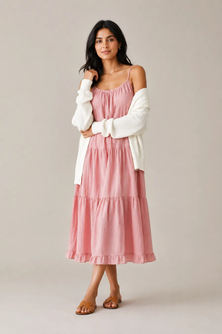 An adult South Asian woman wearing a blush-pink cotton sundress with thin straps, a draped ivory cardigan, and flat tan sandals, soft daytime pose, full body, entire figure from head to feet in frame, centered with headroom