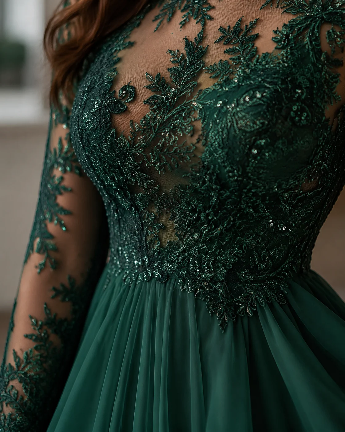 Close-up of a beaded lace bodice in deep emerald showing texture, sequins, and soft folds