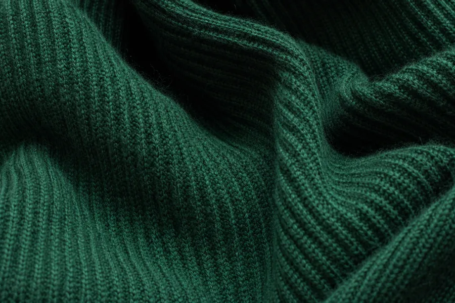 Close-up of richly colored knit fabric showing texture and folds